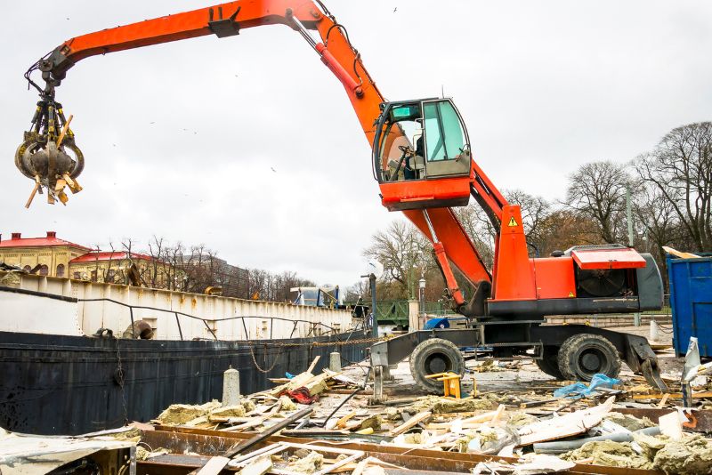 orange excavator moving debris